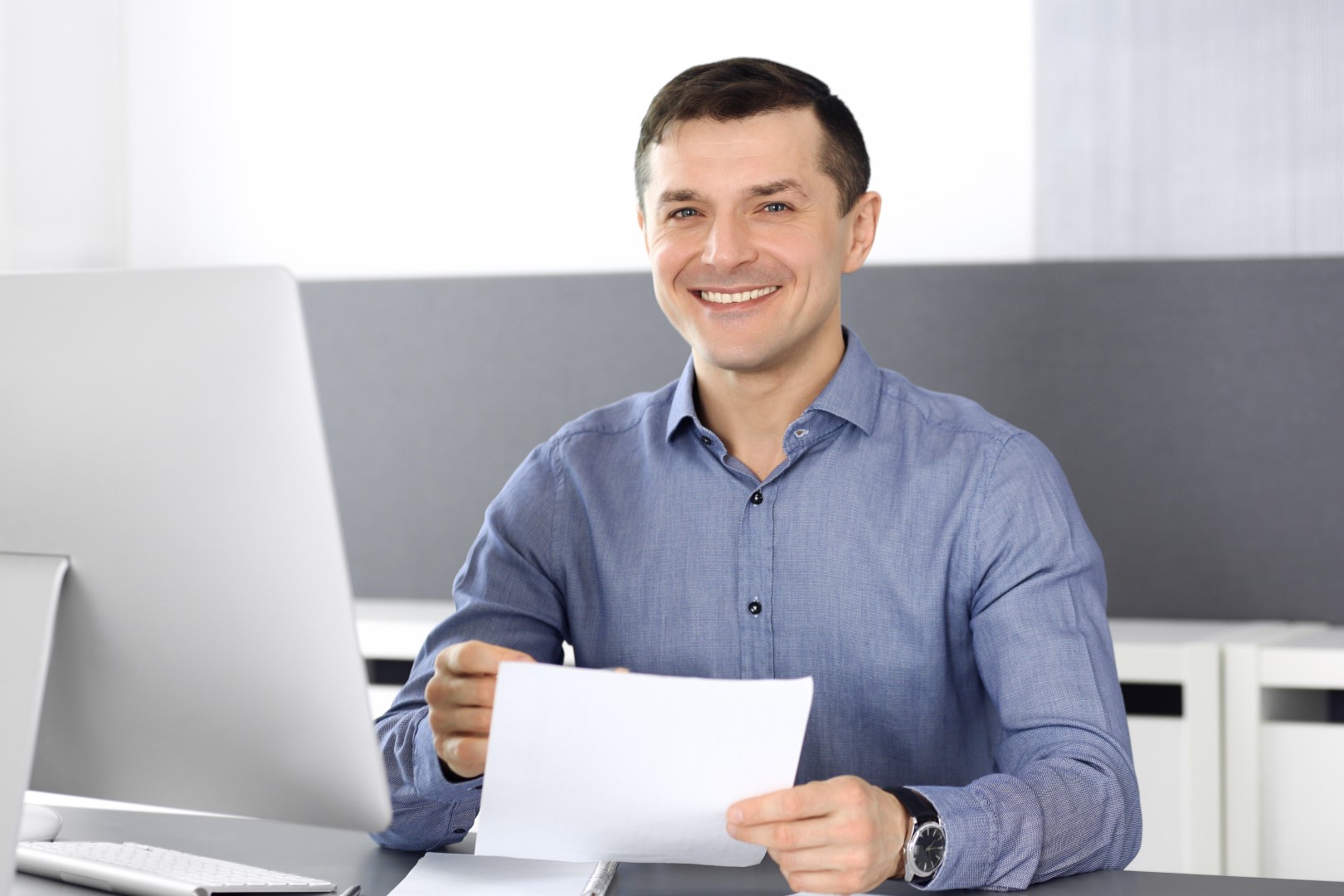 Man sitting at desk who could be a company director.