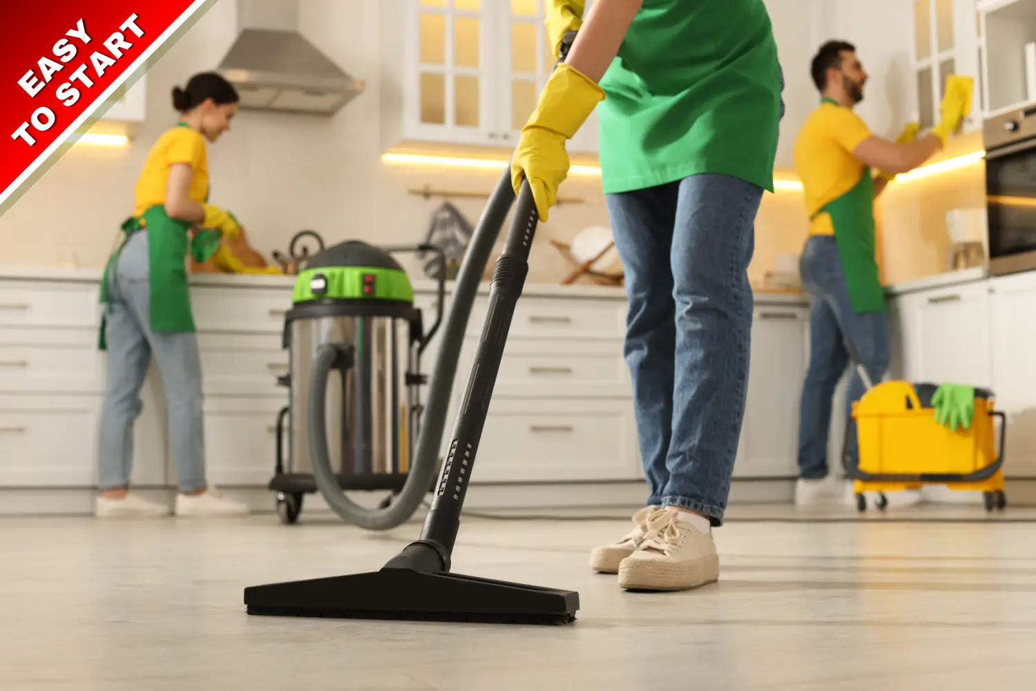 An image showing professional cleaners working, one using a hoover in the foreground.